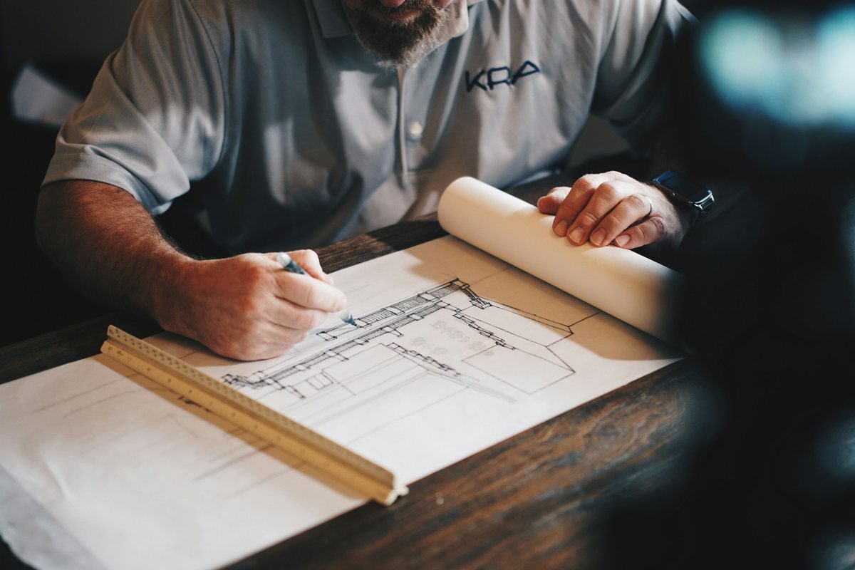 Tradesperson reviewing plans for coordinated property maintenance